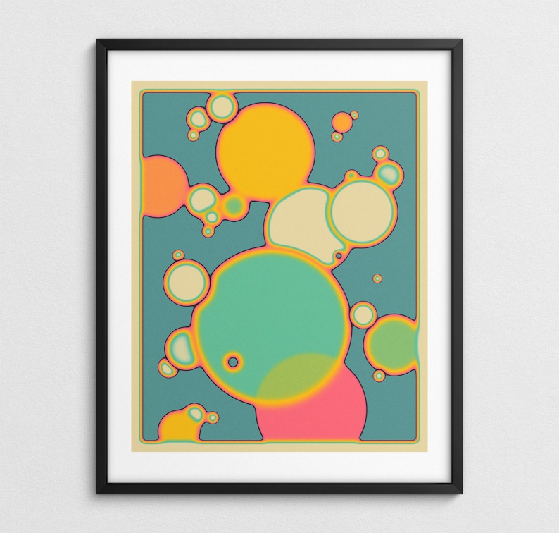 The image is a framed abstract artwork featuring a vibrant and colorful design of overlapping circles in various shades of green, orange, and pink.
