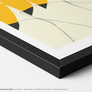 The image is a framed artwork with a black border and a yellow and white abstract design.