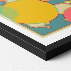 The image is a framed artwork featuring abstract, colorful shapes and patterns in shades of yellow, green, and pink.