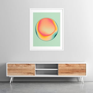 a modern, minimalist living room with a white entertainment center and a framed abstract art piece hanging on the wall above it.
