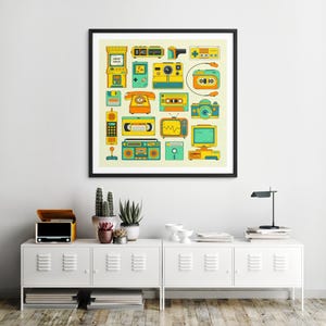 a framed poster of various vintage electronic devices, such as a telephone, radio, and camera, displayed on a wall above a white cabinet with a lamp and other decorative items.