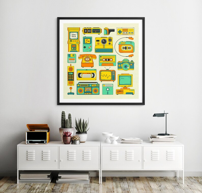 a framed poster of various vintage electronic devices, such as a telephone, radio, and camera, displayed on a wall above a white cabinet with a lamp and other decorative items.