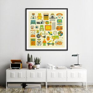 a framed collage of various colorful and whimsical illustrations, including toys, robots, and other playful objects, displayed on a wall above a white cabinet with drawers.