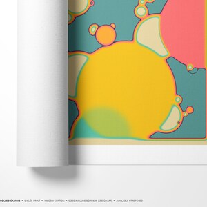 The image is a rolled canvas featuring a vibrant abstract design with various shapes and colors, including yellow, orange, and pink.
