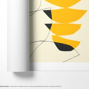 The image is a rolled canvas print featuring abstract geometric shapes in shades of yellow and black.