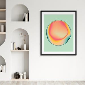 a minimalist living space with a white wall, a framed abstract art piece, and built-in shelving units.