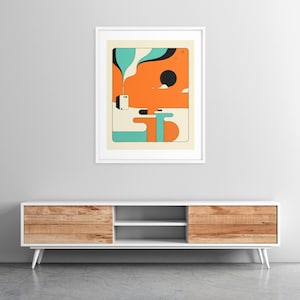 a modern, minimalist living room with a white entertainment center and a framed abstract art piece hanging on the wall above it.