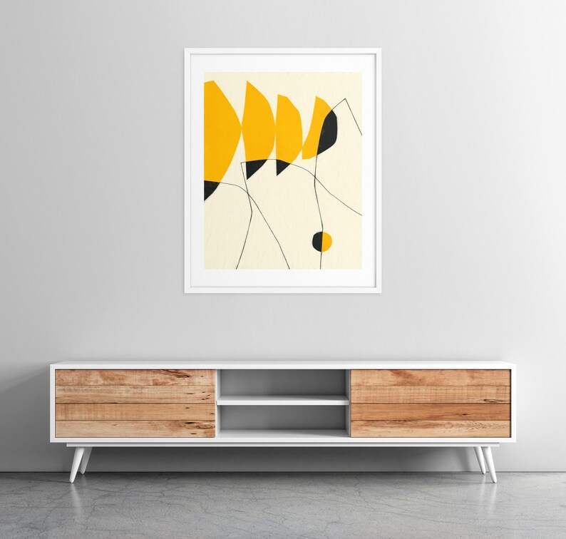 a minimalist design with a white entertainment unit against a gray wall, and a framed abstract art piece above it.