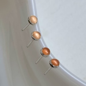 Sweet and Petite 3mm Peach Moonstone Stud Earrings Hand Crafted in Sterling Silver. Lightly hammer-textured and bezel set. Ready to ship!