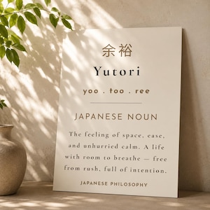 May include: A rectangular off-white wall art print featuring the Japanese kanji for Yutori, the romanized text Yutori, the pronunciation yoo.too.ree, the label JAPANESE NOUN, and a definition describing a life of space, ease, and unhurried calm.