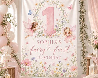 May include: A rectangular fabric backdrop featuring a large pink number one surrounded by a floral wreath, two illustrated fairies with pink wings, and butterflies. The text reads Sophia's fairy first birthday in pink script and block lettering.