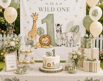 May include: A first birthday party setup featuring a white backdrop with the text HENRY IS A WILD ONE, a large number one, and illustrations of a giraffe, lion, zebra, and elephant. Includes a cake, cupcakes, balloons, and gift boxes.