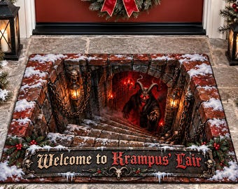 May include: A rectangular doormat featuring a 3D optical illusion of a stone staircase leading into a dark dungeon. The mat displays a horned Krampus figure, hanging lanterns, chains, and the text Welcome to Krampus' Lair in red and white.