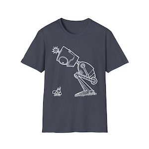 May include: A dark gray short-sleeve t-shirt featuring a white line art graphic of a robot looking down at a small snail on a mushroom. The robot has a square head with a single eye and a starburst detail, standing on a patch of grass.