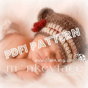May include: A close-up of a sleeping baby wearing a brown and white striped crocheted hat with a red flower accent. The hat has the text "PDF1 PATTERN" on it. The text "www.lbeen.etsy.com monkeyface PHOTOGRAPHY" is also visible in the image.