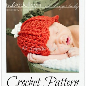 May include: A sleeping baby wearing a bright red crocheted hat with a white flower accent. The hat is textured and covers the baby's head and ears. The words "Crochet Pattern" are written in a script font at the bottom of the image.