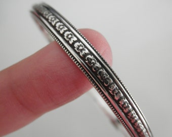 Sterling silver bangle bracelet with tiny flower design