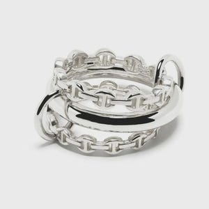 May include: A silver ring featuring a central smooth, polished band flanked by two thinner chains with oval, H-shaped links. The metal has a bright, reflective finish, and the interior of the band is stamped with the hallmark 925, indicating sterling silver.