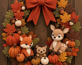 May include: A decorative wreath featuring a large crocheted orange bow at the top, surrounded by crocheted autumn leaves, acorns, and pumpkins. Centered are three crocheted figures: a fox, a hedgehog, and a deer, all in earthy tones.