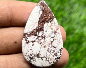 May include: A teardrop-shaped cabochon stone featuring a white base with intricate, web-like brown and dark copper-colored matrix patterns throughout the surface. The stone has a smooth, polished finish and a distinct pointed top edge.