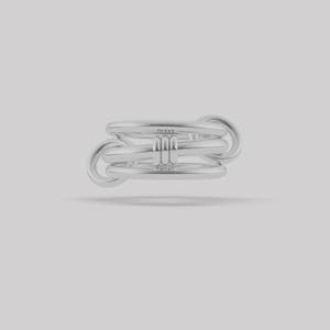 May include: A silver-toned ring featuring a multi-band design with three smooth, rounded horizontal bands connected by a vertical bar element in the center. The structure creates an interlocking appearance with circular loops on the sides.