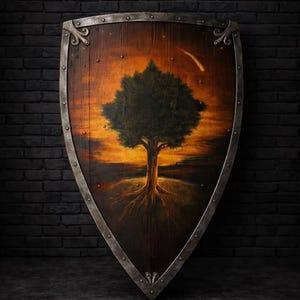 May include: A wooden heater shield with a metal rim and rivets, featuring a painted scene of a tree against an orange sunset sky. The text Berlin MedievalForge is printed at the top centre of the shield, which has a pointed bottom edge.