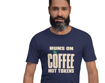 May include: A navy blue short-sleeve t-shirt featuring the cream-colored text "RUNS ON COFFEE NOT TOKENS" printed on the chest, with three small green steam lines above the word COFFEE, displayed on a person with a dark beard.