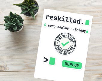 May include: A sticker sheet featuring tech-themed designs including the text reskilled. with a green square, sudo deploy --friday, a circular badge reading STILL NOT A ROBOT HUMAN VERIFIED with a green checkmark, a greater than symbol, and a DEPLOY button.
