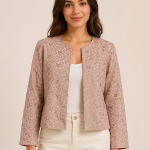 May include: A dusty rose open-front jacket featuring a metallic gold floral vine pattern throughout. The jacket has long sleeves, a collarless round neckline, and a straight hemline, worn over a plain white tank top and cream-coloured trousers.