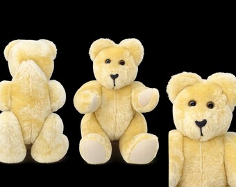 Op de afbeelding: Een pluche teddybeer met lichtgele vacht, donkerbruine ogen en een geborduurde zwarte neus. De beer wordt getoond vanaf de achterkant, de voorkant en in close-up van het gezicht, met gladde lichtgekleurde stof op de voetzolen en handpalmen.