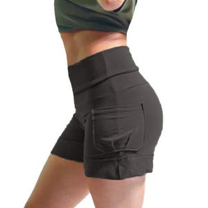 May include: Black athletic shorts with a high waistband and pockets. The shorts are made of a stretchy material and are designed for workouts or casual wear. The shorts are shown from the side.