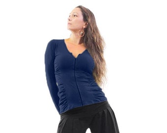 May include: A navy blue long-sleeved shirt with a zipper down the front. The shirt has a v-neck and is fitted. The model is wearing black pants.