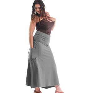 May include: A gray maxi skirt with a large pocket on the left side. The skirt is made of a soft, stretchy fabric and has a drawstring waist.