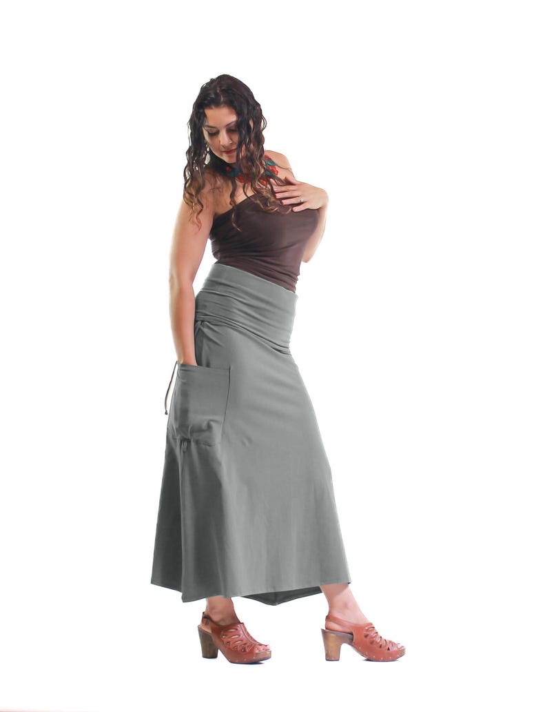May include: A gray maxi skirt with a large pocket on the left side. The skirt is made of a soft, stretchy fabric and has a drawstring waist.