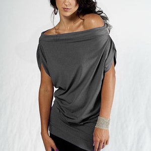 May include: A gray off-the-shoulder top with short sleeves. The top is made of a soft, stretchy fabric and has a relaxed fit.