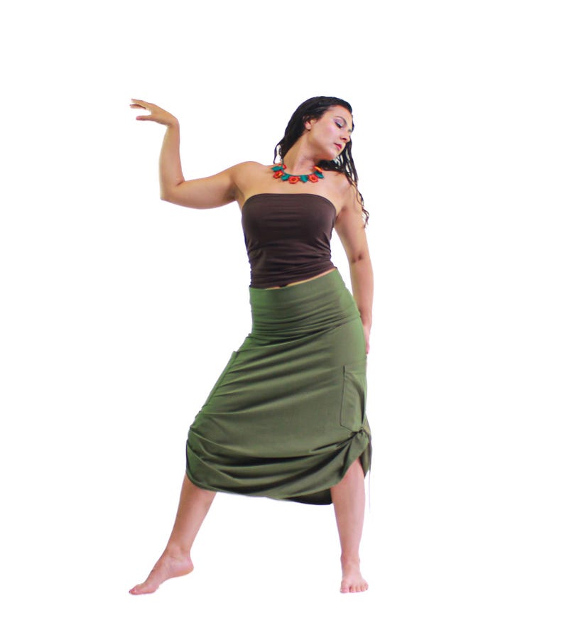 May include: A woman wearing a brown tube top and a long, olive green skirt with a gathered detail at the bottom. She is wearing a multi-colored necklace.