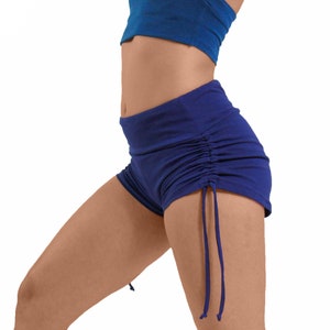 May include: A pair of blue, high-waisted, cotton shorts with a drawstring detail on the sides.