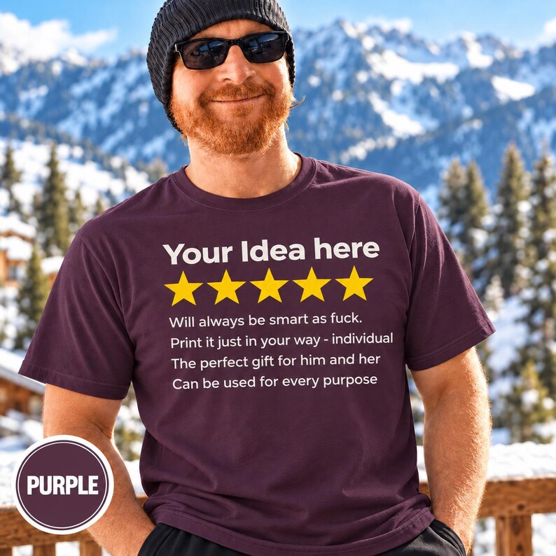 Bearded man in a beanie and sunglasses in front of snowy mountains wearing the personalized golden 5-star review T-shirt by SarcasmArt in Grape (purple), with your custom title, five golden stars and four lines of your own review text in white.