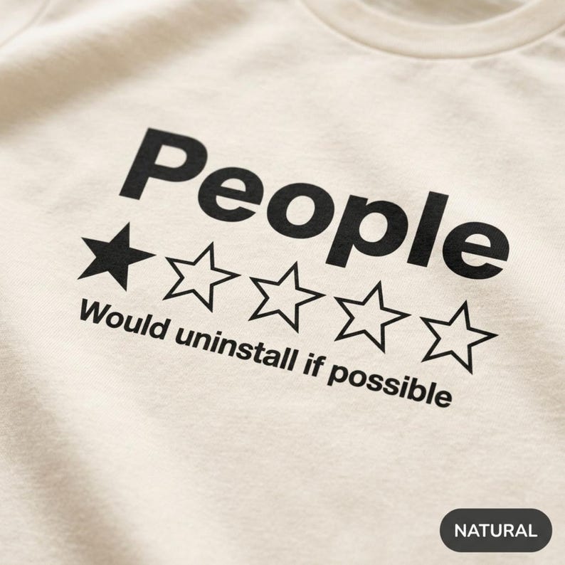 Close-up of the one-star People review print on the Natural "People – 1 Star, Would Uninstall If Possible" funny review T-shirt by SarcasmArt.
