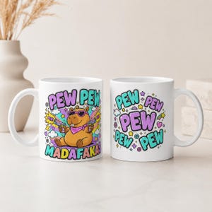 Both sides of the "Pew Pew Madafakas" capybara coffee mug by SarcasmArt: the capybara design on one side and PEW PEW lettering on the other.