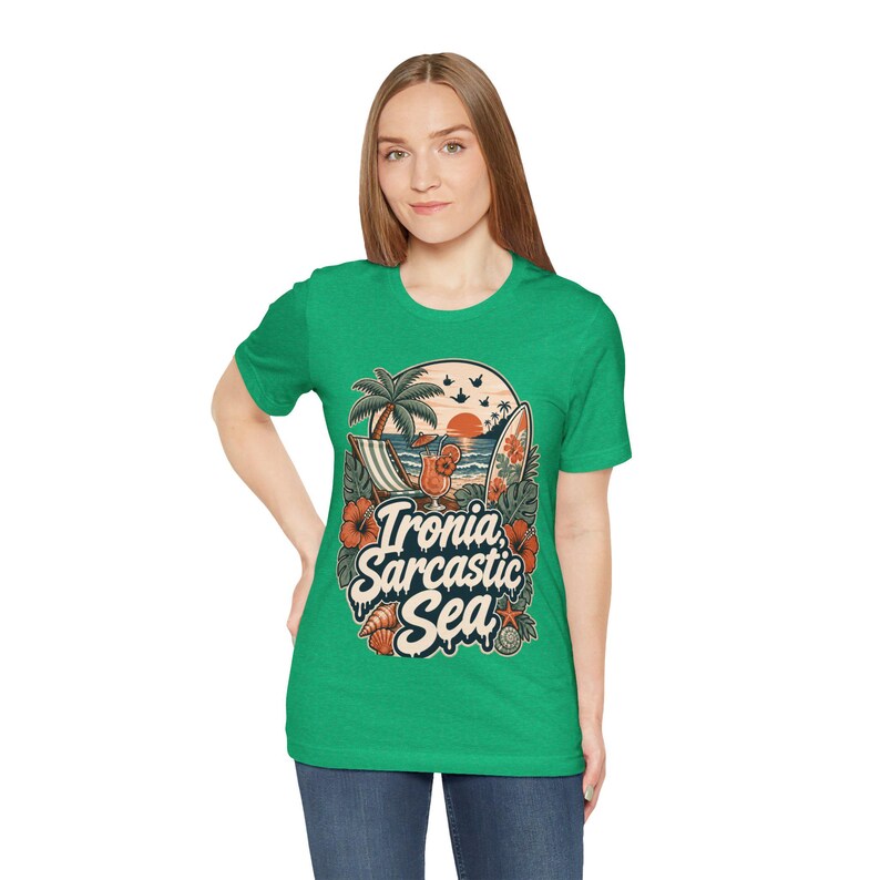 Woman in jeans wearing the "Ironia, Sarcastic Sea" retro beach T-shirt by SarcasmArt in kelly green.
