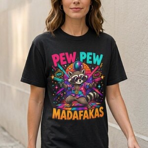 Woman in jeans wearing the "Pew Pew Madafakas" raccoon meme T-shirt by SarcasmArt in Black.