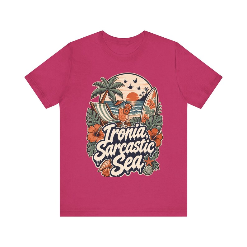 "Ironia, Sarcastic Sea" retro beach T-shirt by SarcasmArt in raspberry pink on a plain background, showing a vintage tropical beach scene with palm tree, deck chair, cocktail, surfboard, sunset, hibiscus flowers and shells around the script Ironia, Sarcastic Sea.