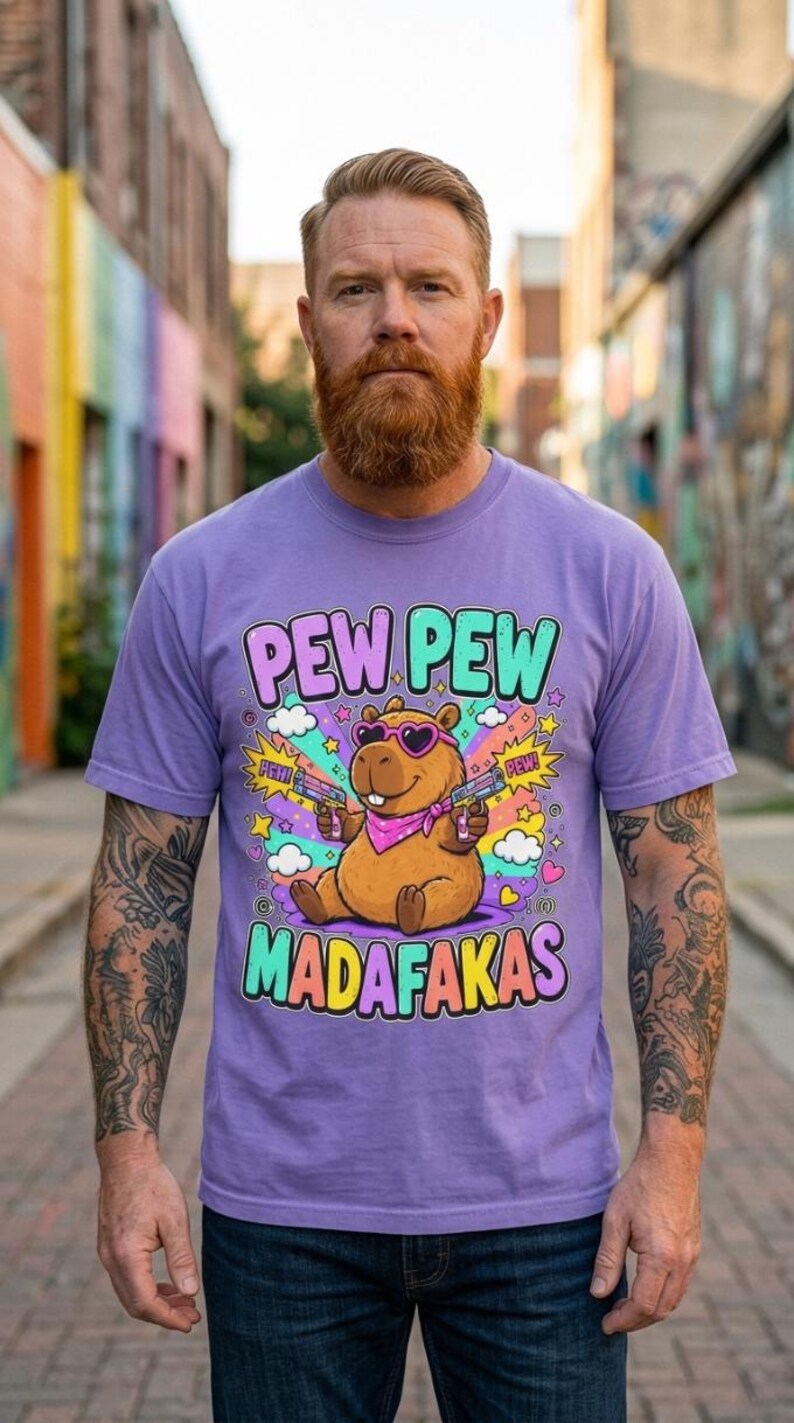 Bearded man in a colorful graffiti alley wearing the "Pew Pew Madafakas" capybara meme T-shirt by SarcasmArt in Violet.