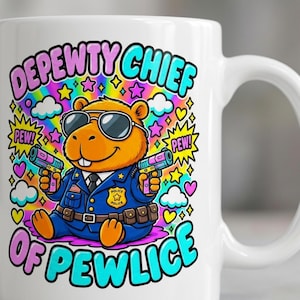 Close-up of the "Depewty Chief of Pewlice" capybara coffee mug by SarcasmArt: a capybara police officer in sunglasses and a blue uniform with colorful comic bursts and DEPEWTY CHIEF OF PEWLICE lettering.