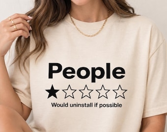May include: A beige short-sleeved t-shirt featuring the black text "People" above a graphic of five stars, with only the first star filled in black. Below the stars, the black text reads "Would uninstall if possible" in a simple font.
