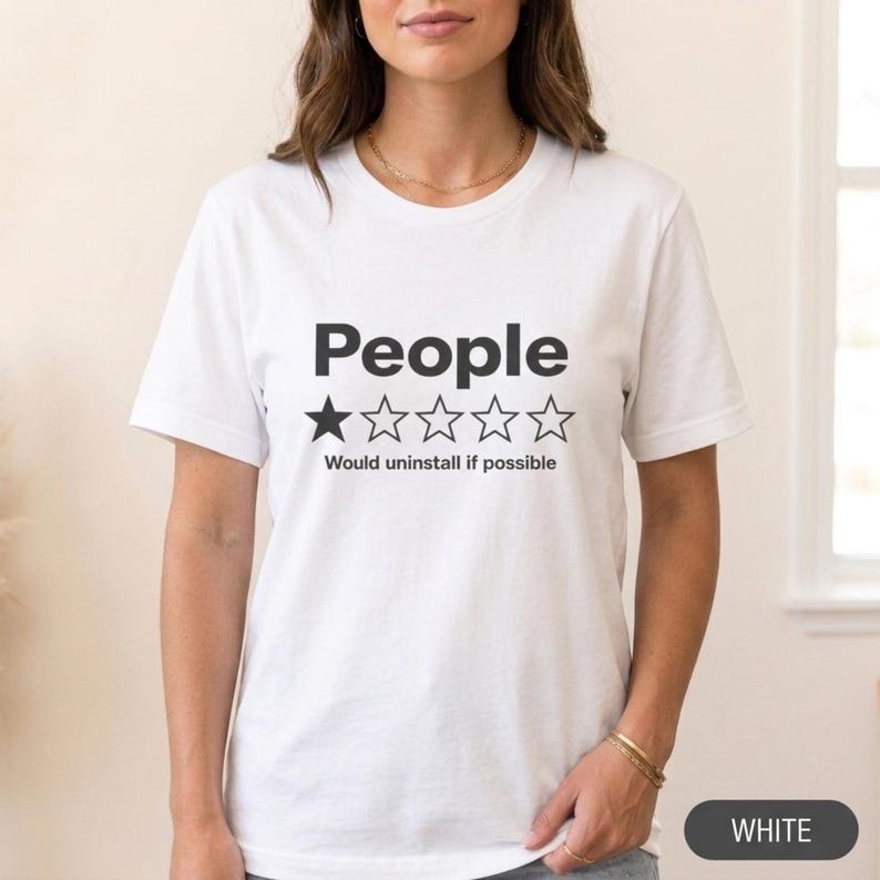 Woman wearing the "People – 1 Star, Would Uninstall If Possible" funny review T-shirt by SarcasmArt in White, a minimalist sarcastic introvert shirt.