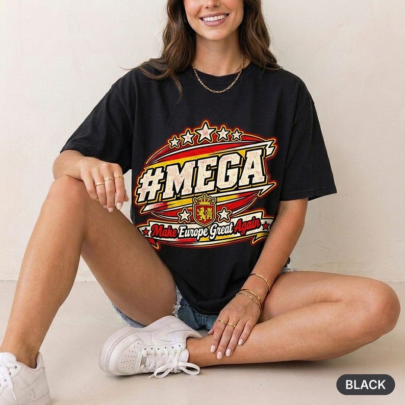 Woman sitting on the floor in a bright studio wearing the "#MEGA Make Europe Great Again" Spain T-shirt by SarcasmArt in Black.