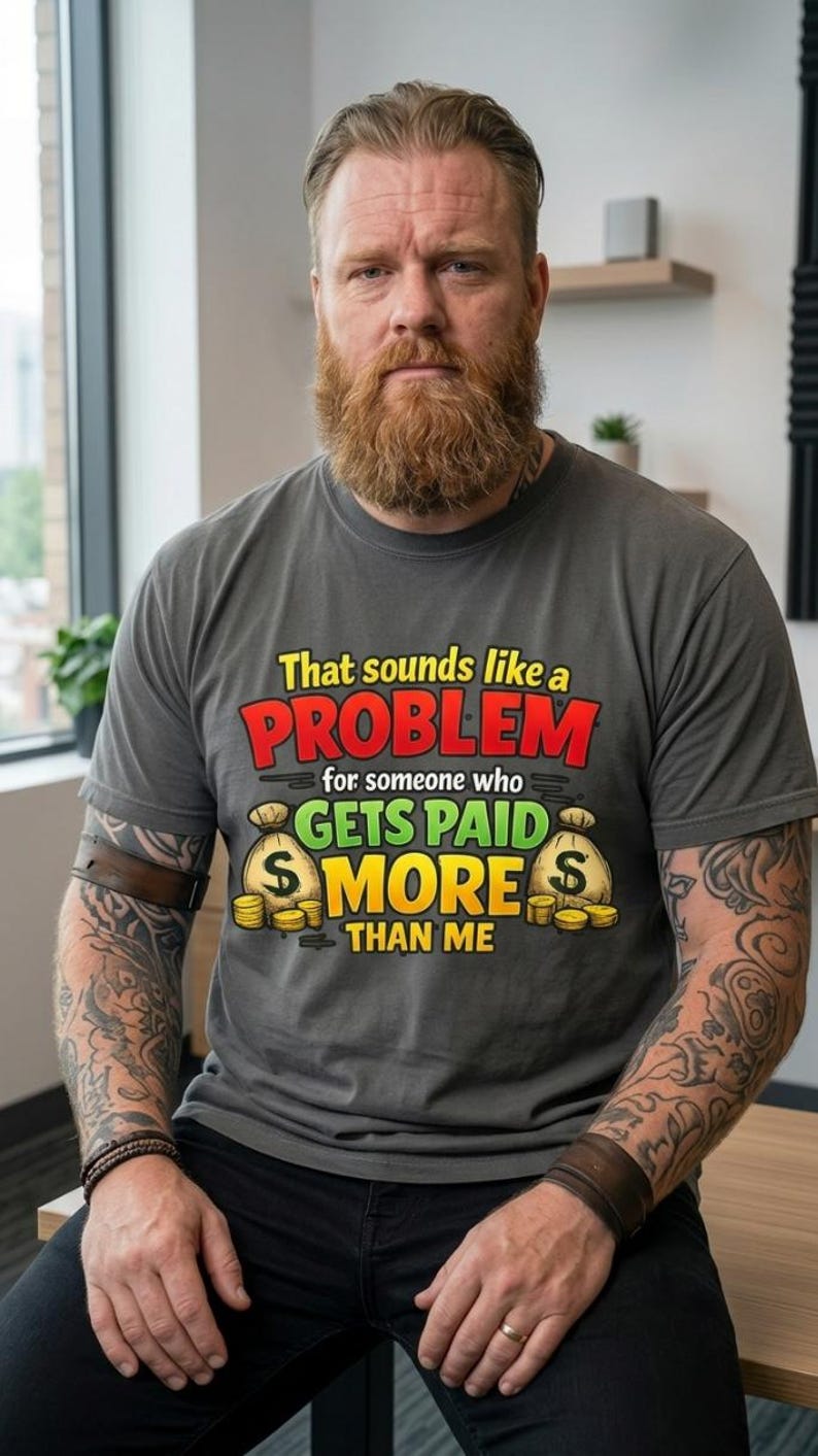 Bearded man wearing the "That Sounds Like a Problem for Someone Who Gets Paid More Than Me" sarcastic coworker T-shirt by SarcasmArt in Pepper.