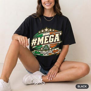 Woman sitting on the floor in a bright studio wearing the "#MEGA Make Europe Great Again" Ireland T-shirt by SarcasmArt in Black.